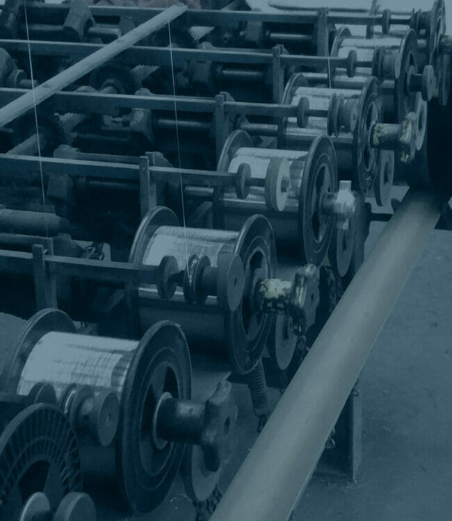 Multiple wire drawing machines spooling custom wire | Wire drawing company